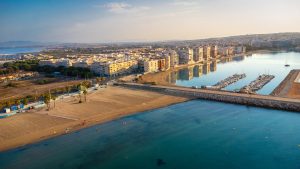 Aerial view of the beach, seafront and marina of Torrevieja at sunrise